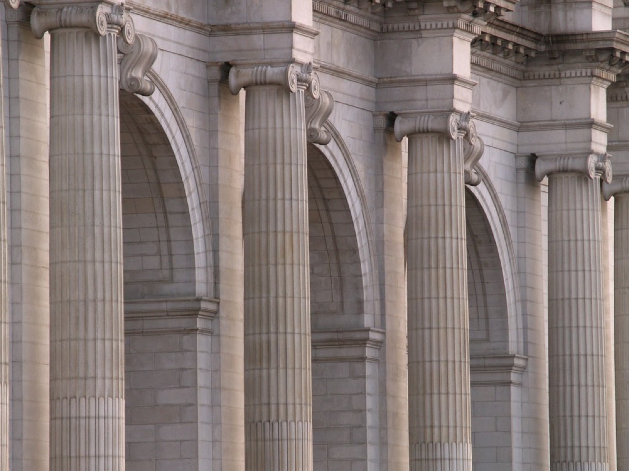 Rows of tall classical stone columns and arches.